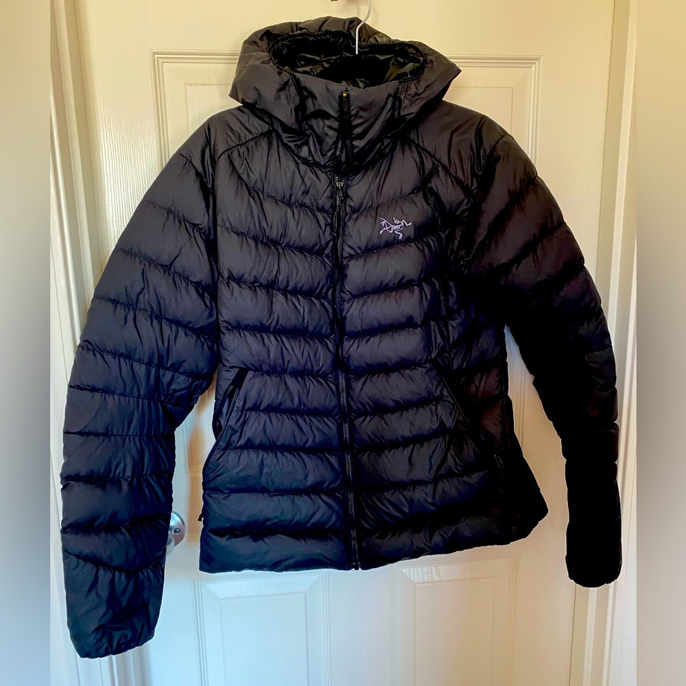 Black arc’teryx hooded jacket.